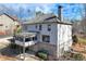 Exterior of home with a spacious deck, patio and lush wooded backyard providing privacy at 6225 Leeward Tide Ct, Cumming, GA 30041