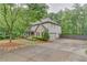 Charming two-story home with a covered front porch, manicured landscaping, and a long concrete driveway at 6225 Leeward Tide Ct, Cumming, GA 30041