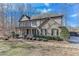 Inviting two-story home featuring a cozy front porch and meticulously manicured landscaping at 6225 Leeward Tide Ct, Cumming, GA 30041