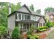 Two-story home with a covered porch, brick accents, and meticulously landscaped front yard at 6225 Leeward Tide Ct, Cumming, GA 30041