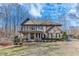Beautifully landscaped front yard with a charming two-story home, featuring a covered porch at 6225 Leeward Tide Ct, Cumming, GA 30041