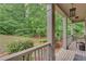 Covered front porch with brick flooring, decorative pillars, and view of landscaped front yard at 6225 Leeward Tide Ct, Cumming, GA 30041