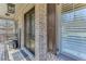 Charming front porch featuring a brick facade, ornate double doors, and exterior details at 6225 Leeward Tide Ct, Cumming, GA 30041