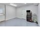 Spacious garage with epoxy floors, white walls, storage and convenient access door at 6225 Leeward Tide Ct, Cumming, GA 30041