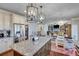 Open concept kitchen flows into the living room with a large island, granite countertops and stainless steel appliances at 6225 Leeward Tide Ct, Cumming, GA 30041