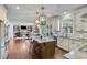 Spacious kitchen with stainless steel appliances, granite countertops, large island and pendant lighting at 6225 Leeward Tide Ct, Cumming, GA 30041