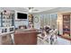 Inviting living room with stone fireplace, built-in shelves, and backyard views at 6225 Leeward Tide Ct, Cumming, GA 30041