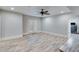 Spacious living room with wood look flooring, ceiling fan, and french doors to an outdoor patio at 6225 Leeward Tide Ct, Cumming, GA 30041