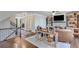 Cozy living room with a stone fireplace, hardwood floors, built-in shelves and staircase at 6225 Leeward Tide Ct, Cumming, GA 30041