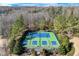 Overhead view of the community tennis court, surrounded by mature trees at 6225 Leeward Tide Ct, Cumming, GA 30041
