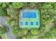 Aerial view of community tennis and pickleball courts surrounded by lush landscaping at 6225 Leeward Tide Ct, Cumming, GA 30041