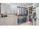 Organized walk-in closet with built-in shelving, drawers, and ample hanging space for clothing and accessories at 6225 Leeward Tide Ct, Cumming, GA 30041