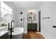 A modern bathroom featuring a soaking tub, tiled shower and stylish vanity with wood look floors at 780 Gardenside Se Cir, Marietta, GA 30067