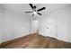 A clean bedroom features wood-look flooring, a modern ceiling fan, and white walls with white doors at 780 Gardenside Se Cir, Marietta, GA 30067