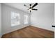 Bright bedroom with two windows, light walls, wood-look flooring, and a ceiling fan at 780 Gardenside Se Cir, Marietta, GA 30067
