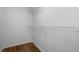 A walk-in closet with wood look floors and a metal shelf at 780 Gardenside Se Cir, Marietta, GA 30067