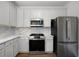 Modern kitchen with stainless steel appliances, white cabinets, and stylish backsplash at 780 Gardenside Se Cir, Marietta, GA 30067