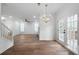 Open-concept space with a chandelier, hardwood floors, fireplace, and access to the outdoors at 780 Gardenside Se Cir, Marietta, GA 30067