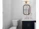 Elegant powder room with a navy vanity, white countertop, and stylish mirror at 780 Gardenside Se Cir, Marietta, GA 30067