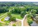 An aerial view reveals a private estate home surrounded by lush forests and a tranquil pond at 878 Forrester Cemetery Rd, Covington, GA 30014