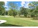 Lush greenery and a tranquil pond create a serene backyard setting for this charming property at 878 Forrester Cemetery Rd, Covington, GA 30014