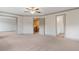 Expansive bedroom featuring neutral walls, carpet, and multiple doorways at 878 Forrester Cemetery Rd, Covington, GA 30014