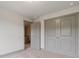 Cozy bedroom featuring double doors for closet space, plush carpet, and neutral walls at 878 Forrester Cemetery Rd, Covington, GA 30014