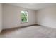 This bedroom features plush carpeting, a window with natural light, and soft, neutral paint at 878 Forrester Cemetery Rd, Covington, GA 30014