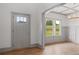 Dining Room showcasing the hardwood floors, grey wainscotting, and elegant chandelier at 878 Forrester Cemetery Rd, Covington, GA 30014