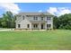 This inviting two-story home has a charming covered porch and is set on a sprawling green lawn at 878 Forrester Cemetery Rd, Covington, GA 30014