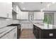 Bright kitchen with white cabinetry, stainless steel appliances, and a gray marble island at 878 Forrester Cemetery Rd, Covington, GA 30014