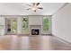 Bright living room with hardwood floors, fireplace, and access to the outdoors at 878 Forrester Cemetery Rd, Covington, GA 30014