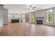 Open-concept floor plan with hardwood floors, kitchen, fireplace, and natural light at 878 Forrester Cemetery Rd, Covington, GA 30014