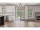 Open concept living area with kitchen and access to outdoor patio and fireplace at 878 Forrester Cemetery Rd, Covington, GA 30014