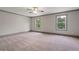 Spacious main bedroom with carpet, neutral paint, and large windows for ample light at 878 Forrester Cemetery Rd, Covington, GA 30014