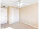 Neutral bedroom features a ceiling fan, closet, and neutral carpet at 1807 Ashborough Cir # G, Marietta, GA 30067