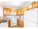Bright kitchen featuring wood cabinets, granite countertops, and white appliances at 1807 Ashborough Cir # G, Marietta, GA 30067
