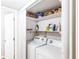 Convenient laundry room features a washer, dryer, and shelving for extra storage at 1807 Ashborough Cir # G, Marietta, GA 30067