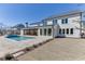 A spacious backyard featuring a pool, covered patio and outdoor kitchen, provides opportunities for outdoor living at 2427 Wolf Meadow Ln, Buford, GA 30518