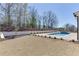 A spacious lawn surrounds a backyard pool and spa with new landscaping, making this a serene outdoor retreat at 2427 Wolf Meadow Ln, Buford, GA 30518