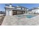 This backyard with pool and hot tub features a covered outdoor kitchen and access to the home at 2427 Wolf Meadow Ln, Buford, GA 30518