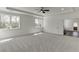 A spacious bedroom with large windows, a ceiling fan, and light carpet at 2427 Wolf Meadow Ln, Buford, GA 30518