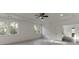 Spacious bedroom with tray ceiling, ceiling fan, recessed lights, and multiple windows at 2427 Wolf Meadow Ln, Buford, GA 30518