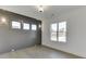 Modern bedroom with a sleek accent wall, neutral paint, ample natural light, and wood flooring at 2427 Wolf Meadow Ln, Buford, GA 30518
