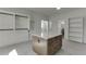 A large closet with built-in shelves and a storage island at 2427 Wolf Meadow Ln, Buford, GA 30518