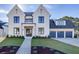 Stunning two-story home featuring a white brick facade, dark window trim, and a well-manicured front lawn at 2427 Wolf Meadow Ln, Buford, GA 30518