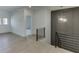Bright hallway featuring light hardwood floors and a modern light fixture at 2427 Wolf Meadow Ln, Buford, GA 30518