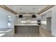 Spacious kitchen with island, showcasing gray cabinetry, stainless appliances, and stylish pendant lighting at 2427 Wolf Meadow Ln, Buford, GA 30518