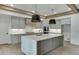 Well-lit kitchen featuring an island with bar seating, modern cabinetry, and stainless steel appliances at 2427 Wolf Meadow Ln, Buford, GA 30518