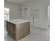 Kitchen island with counter seating, drawers, and cabinets; unfinished room at 2427 Wolf Meadow Ln, Buford, GA 30518